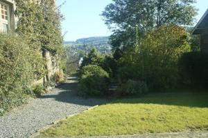 a garden with a path leading to a house at Villa Belle Epoque in Hamoir