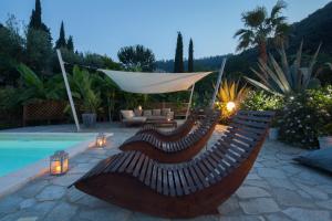 a wooden bench sitting next to a swimming pool at La Musa in Lerici