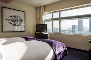 a hotel room with a bed and a large window at Sofitel Casablanca Tour Blanche in Casablanca