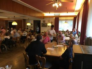 a group of people sitting at a table in a restaurant at Monteurzimmer im Schwabenland in Donzdorf