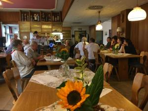 a group of people sitting at tables in a restaurant at Monteurzimmer im Schwabenland in Donzdorf