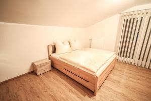 1 dormitorio con 1 cama y suelo de madera en Landhaus zur Tanne, en Feld am See