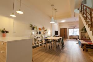 a kitchen and dining room with a table and chairs at 01+ Home in Jiaoxi