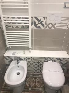 a bathroom with a toilet and a sink at Palazzo D'Amaro Historical Residence in Boscotrecase