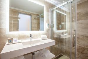 a bathroom with a sink and a shower at Grupotel Los Príncipes & Spa in Playa de Muro