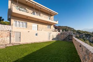 a large house with a large yard in front of it at Villa Vamagia BY APOKORONAS-VILLAS in Plaka