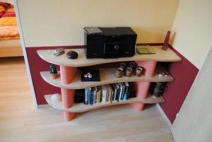 a small shelf with a microwave on top of it at CasaCreativa in Bad Windsheim