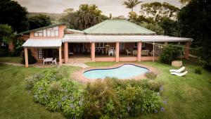 an aerial view of a house with a swimming pool at Ku-Boboyi River Lodge in Port Edward