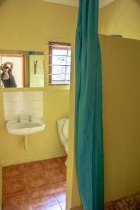 a bathroom with a sink and a toilet at Ku-Boboyi River Lodge in Port Edward