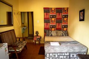 a small room with a bed and a couch at Ku-Boboyi River Lodge in Port Edward