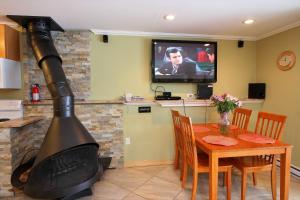 een open haard in een keuken met een tafel en een tv bij Cozy one bedroom Edgemont A1 condo on the shuttle route & ski back trail in Killington
