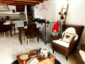 a living room with two chairs and a table at La Chambre des Rêves in Aosta