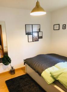 腓特烈港的住宿－Ferienwohnung Mila am Bodensee nähe Messe，一间卧室配有一张床和盆栽植物