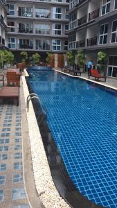 a large swimming pool in front of a building at The Avenue Residences in Pattaya