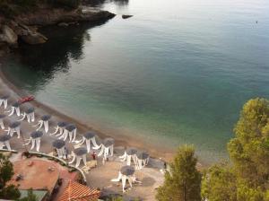 a group of chairs and umbrellas on a beach at Eco del Mare in Lerici