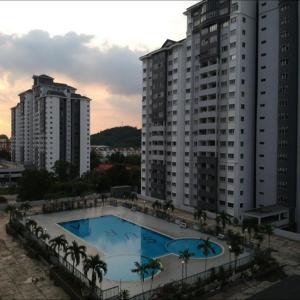 a large swimming pool in front of tall buildings at Cozy Little Room at Suria Kipark Damansara Apartment with Single Bed and a Foldable Mattress in Kuala Lumpur