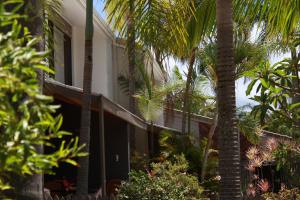 a building with palm trees in front of it at Noosa Sound Resort Noosaville in Noosaville