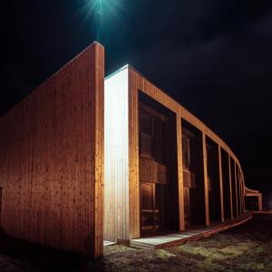 a building at night with the lights on at Hótel Kría in Vík