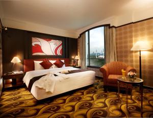 a hotel room with a bed and a large window at Mardhiyyah Hotel and Suites in Shah Alam