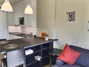 a living room with a couch and a kitchen at Studio Félicie in Fexhe-le-Haut-Clocher +4 photos