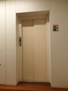an elevator with two doors in a building at Lux Ribeira - ALL INCLUDED in Porto