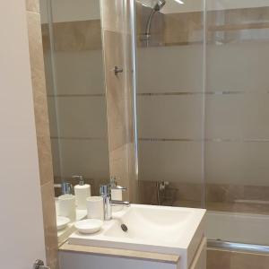 a bathroom with a white sink and a shower at Lux Ribeira - ALL INCLUDED in Porto +9 photos