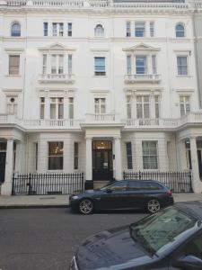 a black car parked in front of a white building at Acacia Hotel in London