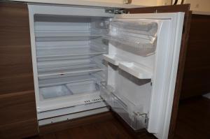 an empty refrigerator with its door open in a kitchen at Primo Maxi in Smokovce