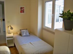リスボンにあるAlmirante 1 Four Bedroomsの小さなベッドルーム(ベッド1台、窓付)