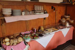 a table with bread and plates of food on it at Hotel "Fränkischer Hof" Garni in Dinkelsbühl