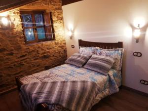 Postel nebo postele na pokoji v ubytování Apartamentos Rurales Casa Carmen