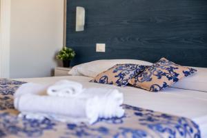 A bed or beds in a room at Elisir Suite Rooms by Marino Tourist