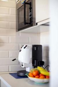 A kitchen or kitchenette at Elisir Suite Rooms by Marino Tourist