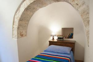Postel nebo postele na pokoji v ubytování Trullo Dimora della Valle