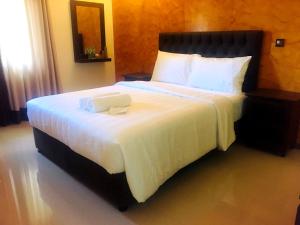 Кровать или кровати в номере Forever City Hotel