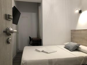 Cama o camas de una habitación en Hostal Rías Bajas