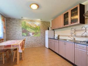 a kitchen with a table and a dining room at Noclegi u Agatki in Ustrzyki Dolne
