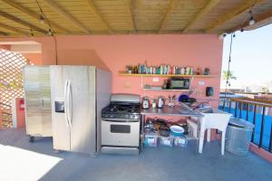 a kitchen with a refrigerator and a counter with a table at Casa Santurce in San Juan
