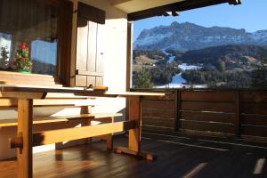 a balcony with a bench and a view of a mountain at CIADIN APPART. in Badia