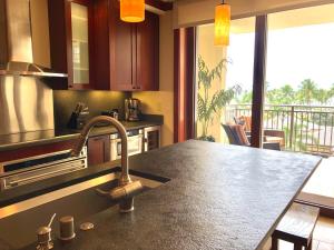 a kitchen with a sink and a counter top at Beach Villas at Ko Olina 5th floor Ocean View in Kapolei