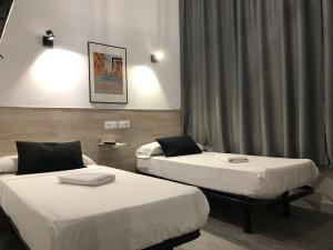 Cama o camas de una habitación en Hostal Rías Bajas