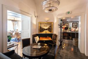 a living room with a table and a couch at Lesar Hotel Angel - Member of Hip Hotels in Ljubljana