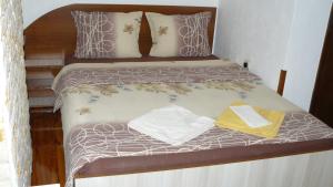 a bed with two mattresses and two towels on it at Geto Apartment in Belogradchik