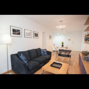 a living room with a couch and a table at Pis del Mercat -aire acondicionado en todas las habitaciones y salón- in Deltebre