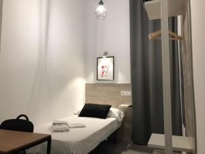 Cama o camas de una habitación en Hostal Rías Bajas