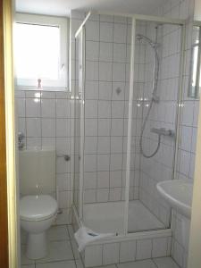 a bathroom with a shower and a toilet and a sink at Haus Mariandl in Düsseldorf +19 photos