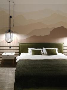 a bedroom with a large bed with a green headboard at DOR Apartment in Poiana Brasov