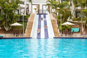 a swimming pool with a slide in a resort at Vale Suíço Resort in Itapeva