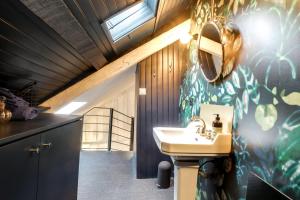 a bathroom with a sink and a mirror and a sink at LE CELESTIN - Centre Historique - in Rennes