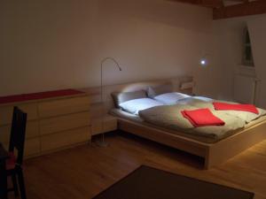 a bedroom with a bed with a red book on it at Historisches Bürgerhaus Dresden -Kulturstiftung- in Dresden
